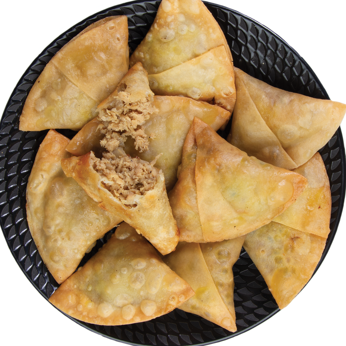 Chicken samosas on a black plate with one open to reveal the filling.