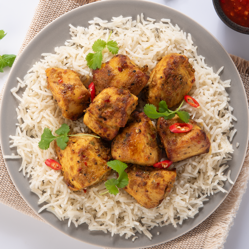 The plate of chicken katsuri tikka bites with boiled rice
